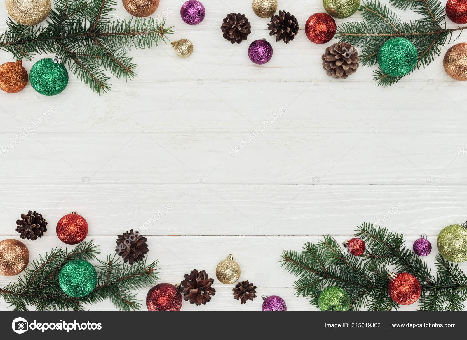 Top view of colorful shiny christmas balls fir twigs and pine cones on white wooden background — Fotografie od VadimVasenin