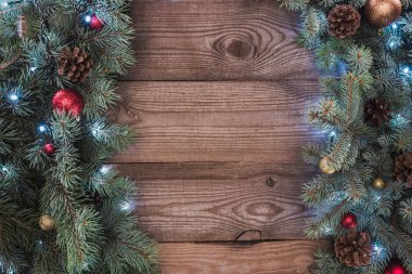 parlak baubles, çam kozalakları ve ışıklı garland, Noel arka plan ile iğne yapraklı twigs üstten görünüm