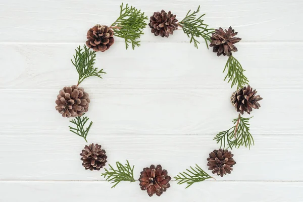 Frame Made Evergreen Coniferous Twigs Pine Cones White Wooden Background — Stock Photo, Image