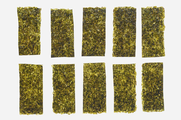 close-up view of green dried nori sheets isolated on white background  