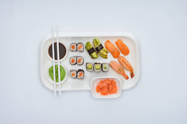 top view of gourmet sushi set with chopsticks isolated on white 