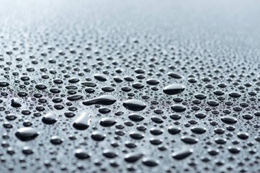 close up view of water drops on grey surface as background clipart