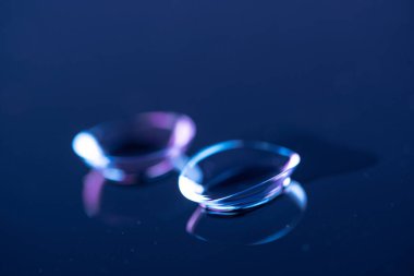 selective focus of contact lenses arranged on blue backdrop clipart