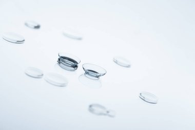 close up view of contact lenses arranged on white background clipart