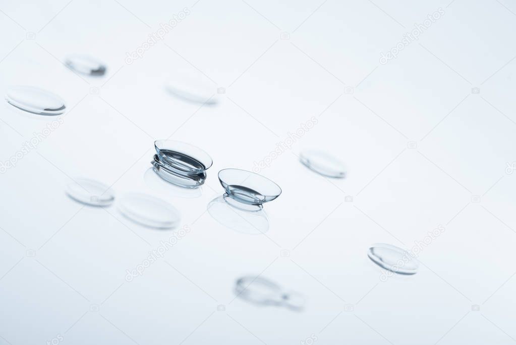 close up view of contact lenses arranged on white background