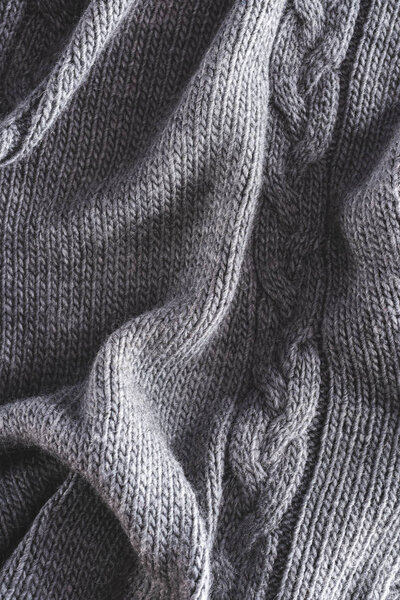 full frame of folded grey knitted cloth as backdrop