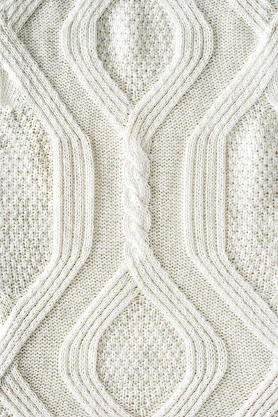 背景にパターンを持つ白いニット布の完全なフレーム — ストック写真
