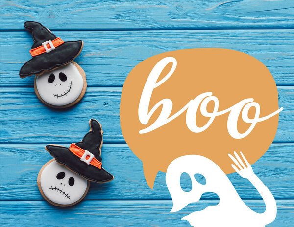 elevated view of delicious homemade halloween cookies on wooden background with ghost and "boo" lettering