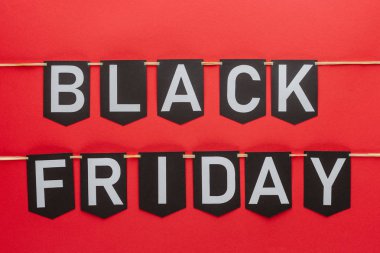 black friday lettering on flag garlands in lines isolated on red clipart