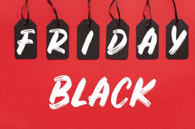 black sale tags isolated on red with black friday lettering clipart