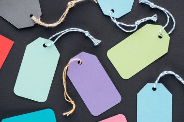 close up of colorful empty sale tags on black background for black friday    clipart