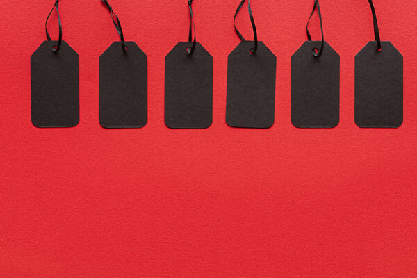 black sale tags isolated on red for special offer on black friday