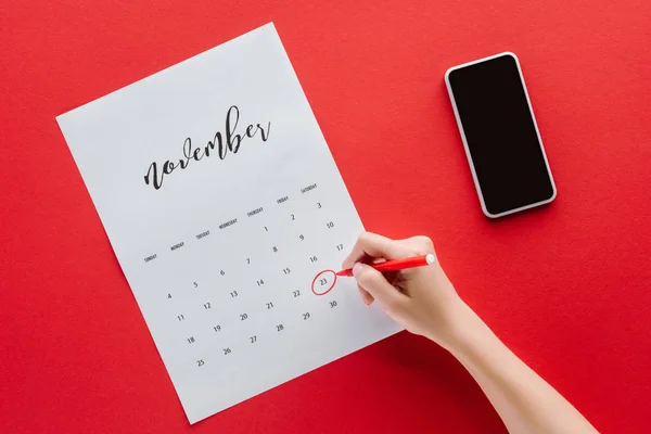 Cropped View Woman Writing Black Friday Calendar November Isolated Red — Stock Photo, Image