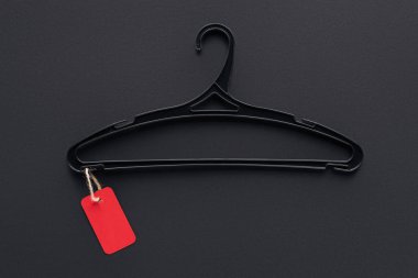 top view of hanger with red sale tag for special offer on black friday clipart