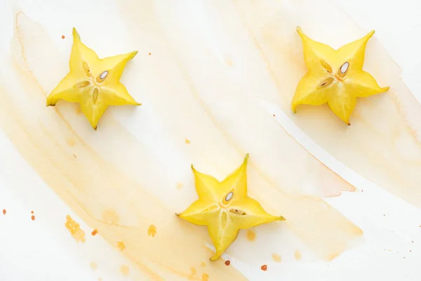 Elevated View Three Sweet Star Fruits White Surface Yellow Watercolor — Stock Photo, Image