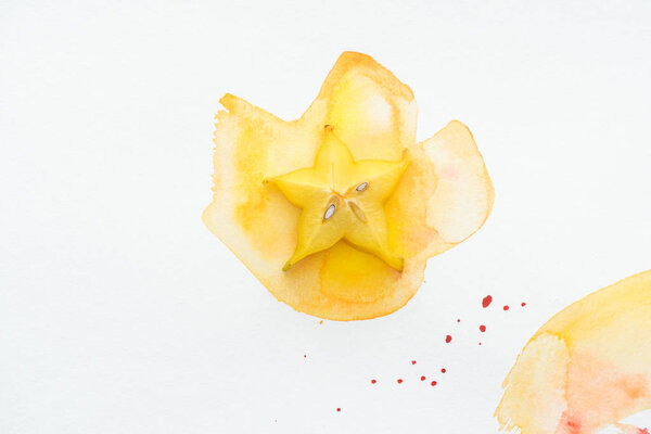 top view of yummy yellow star fruit on white surface with yellow watercolor