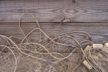 flat lay with fishing net on wooden background clipart