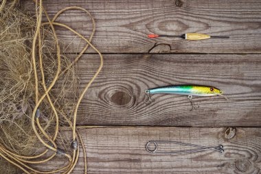 view from above of fishing float, bait and fishing net on wooden planks  clipart