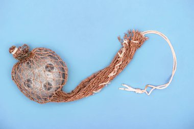 top view of fishing net isolated on blue  clipart