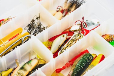 selective focus of fishing tackle and bait in plastic box  clipart