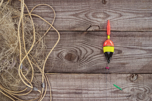 top view of fishing float and fishing net on wooden background 