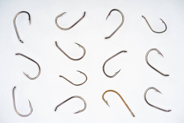 top view of arranged fishing hooks isolated on white 