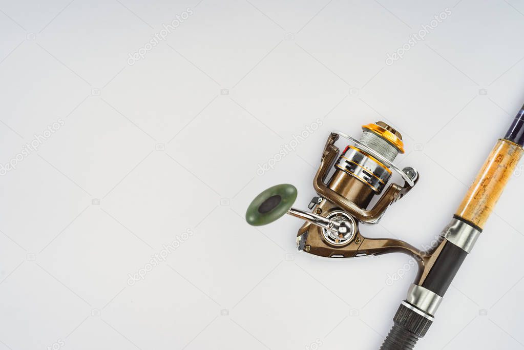 top view of fishing rod isolated on white, minimalistic concept 