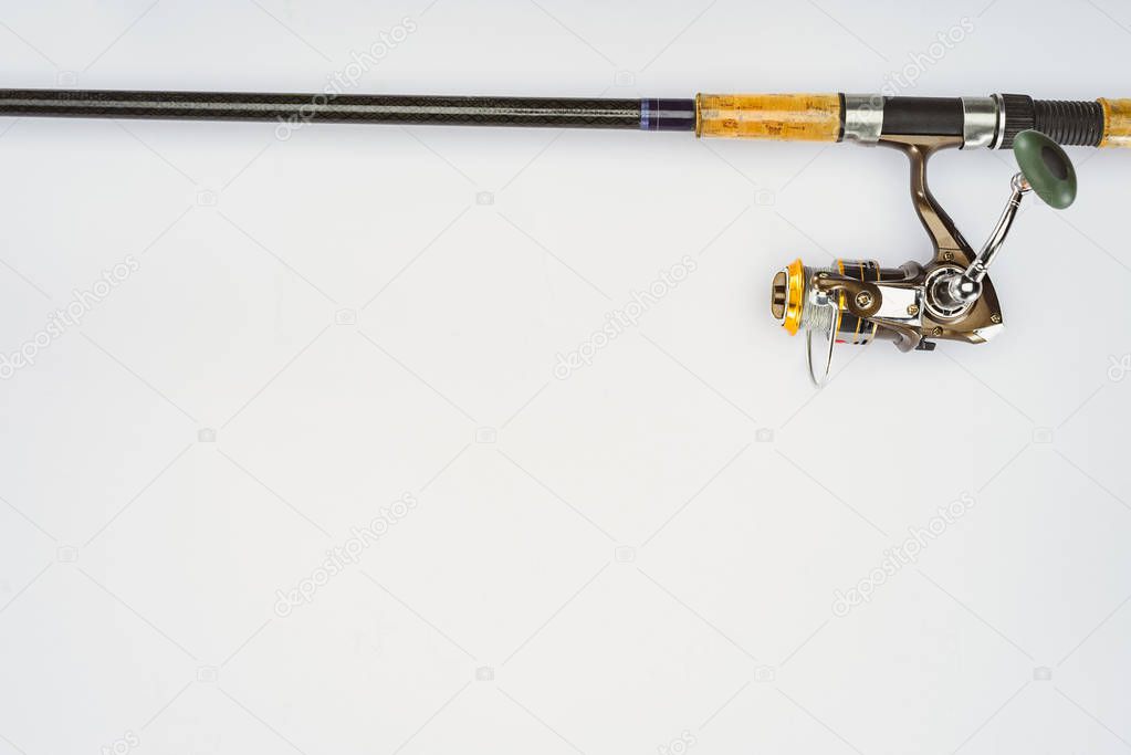 elevated view of fishing rod isolated on white, minimalistic concept 