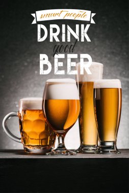 mugs of beer on grey background with 
