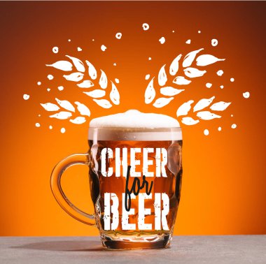 mug of cold beer on orange backdrop with 