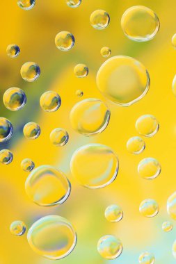 beautiful calm clean water drops on yellow abstract background clipart