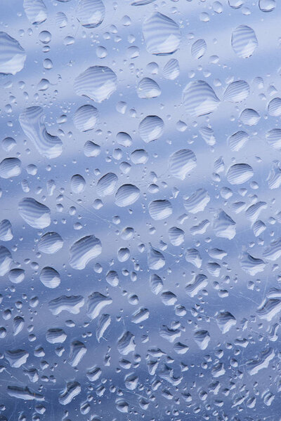 close-up view of beautiful calm transparent water drops on grey abstract background