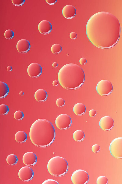 close-up view of beautiful calm transparent water drops on bright red background