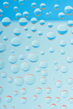 close-up view of transparent droplets on light blue background clipart