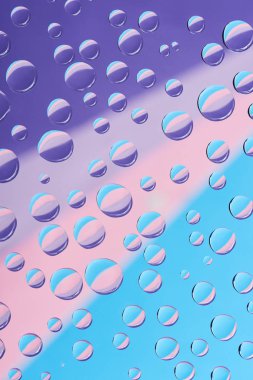 close-up view of transparent water drops on colorful abstract background  clipart