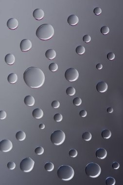 close-up view of transparent clear droplets on grey background   clipart