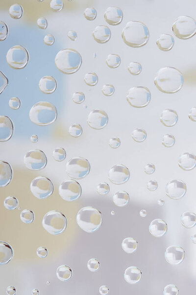 beautiful transparent drops on blurred abstract background 