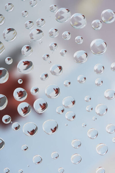 close-up view of transparent rain drops on blurred abstract background