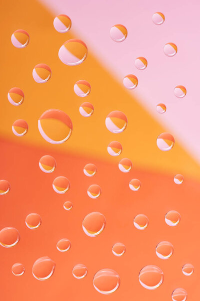 close-up view of transparent water drops on bright background
