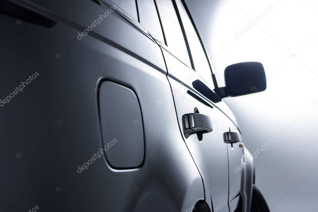 close up view of black luxury car on grey backdrop