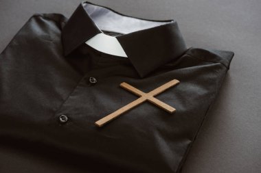 close-up shot of clerical shirt with cross on grey surface clipart