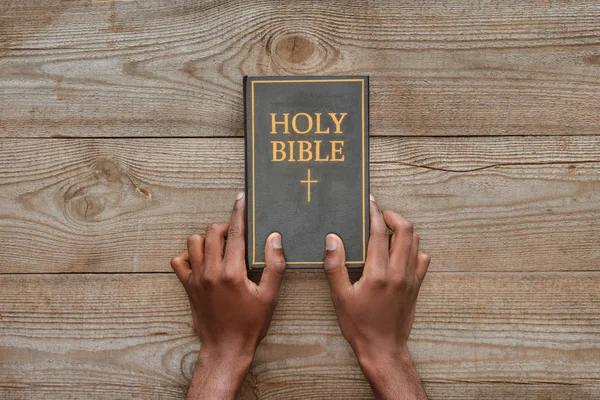 Cropped Shot Man Holding Holy Bible Rustic Wooden Table — Stock Photo, Image