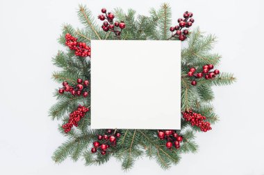 top view of pine tree wreath with Christmas decorations and square blank space in middle isolated on white clipart