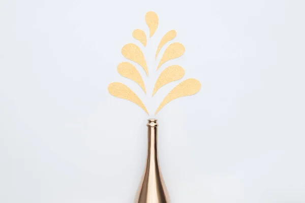 Vista Superior Botella Oro Salpicaduras Decorativas Aisladas Blanco — Foto de stock gratis