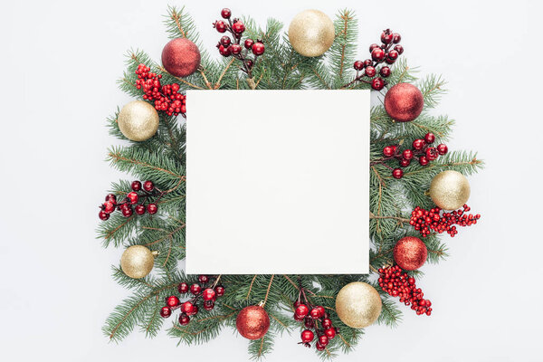 top view of pine tree wreath with Christmas decorations and square blank space in middle isolated on white