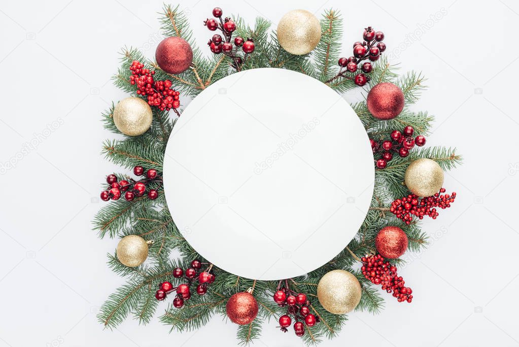 top view of pine tree wreath with Christmas decorations and round blank space in middle isolated on white