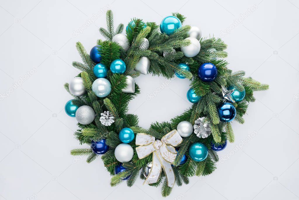 top view of decorative festive wreath with blue and silver christmas toys isolated on white