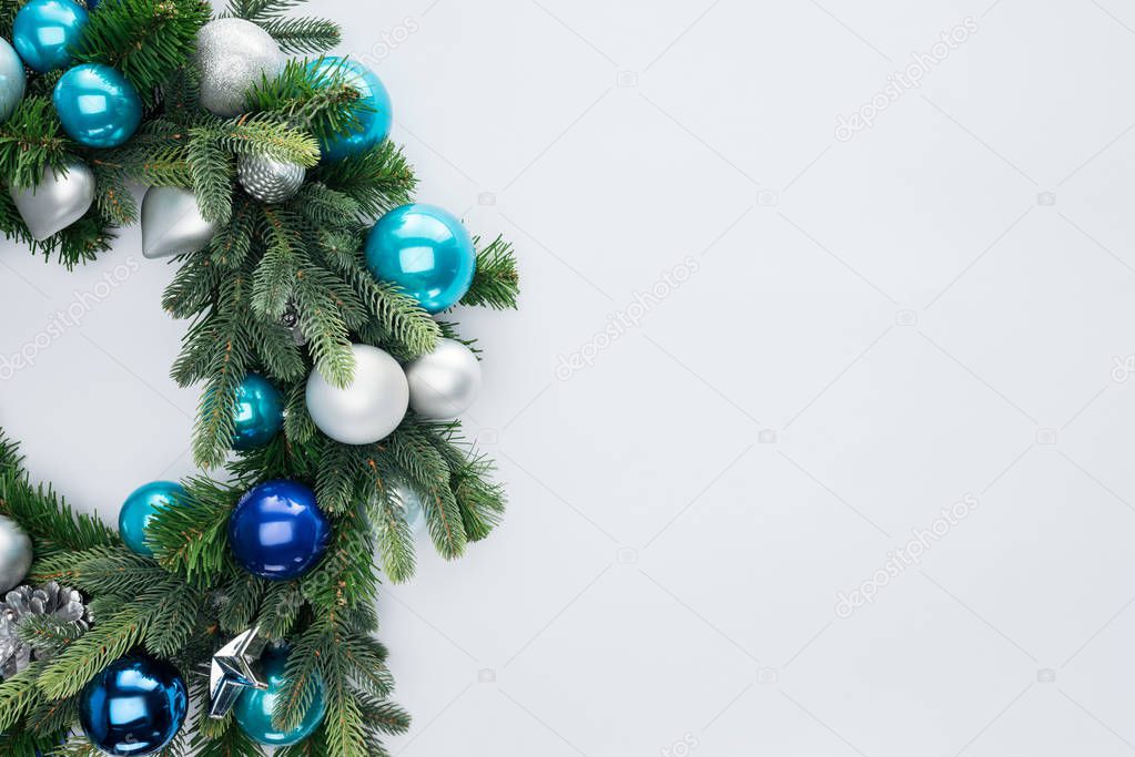 top view of decorative festive wreath with blue and silver christmas toys isolated on white