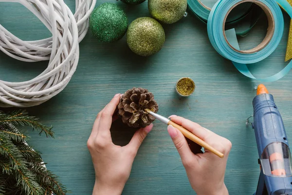 Partial View Woman Coloring Pine Cone Golden Paint Blue Wooden — Stock Photo, Image