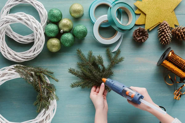Partial view of woman making handmade christmas wreath on blue wooden tabletop — Stock Image Partial View Woman Making Handmade Christmas Wreath Blue Wooden Tabletop Royalty Free Stock Photos